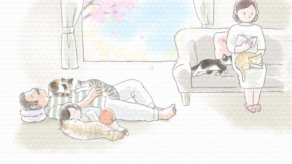 暖かい春の季節、猫たちと一緒にお昼寝する人間の家族