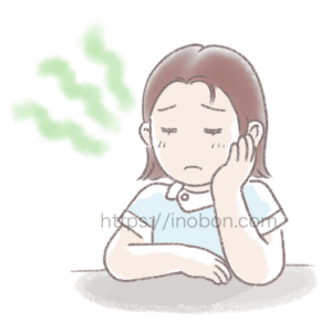 頬杖をついて沈んだ表情の女性の看護師