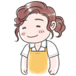 エプロンをつけた女性スタッフが微笑んでいる